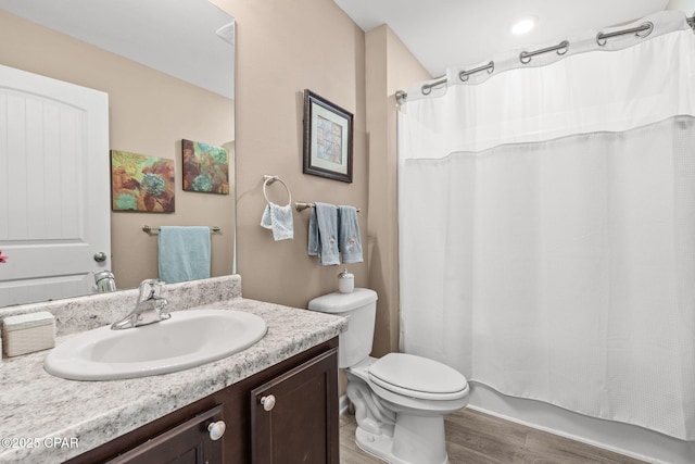 full bathroom featuring toilet, vanity, shower / tub combo, and hardwood / wood-style flooring