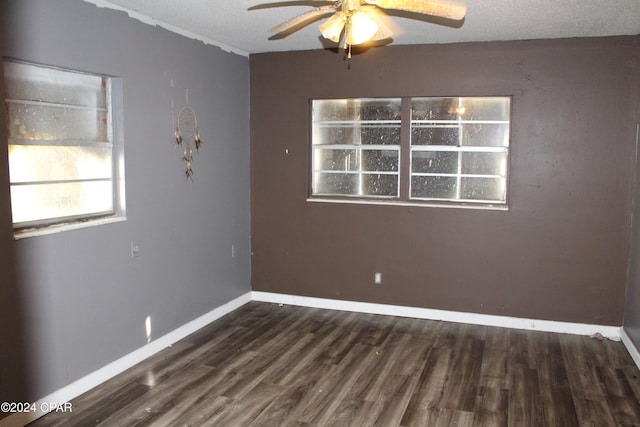 empty room featuring ceiling fan and dark hardwood / wood-style flooring