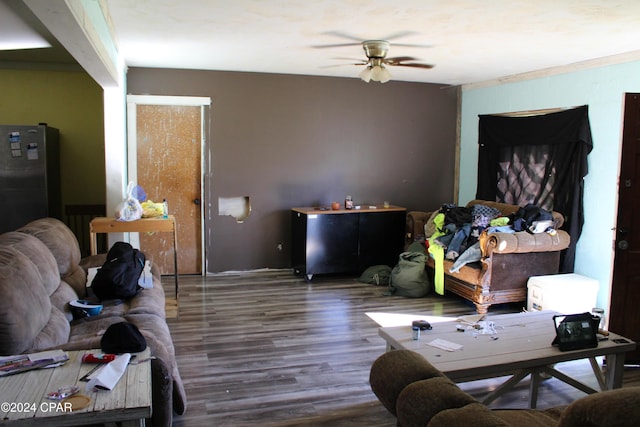 living room with ceiling fan and dark hardwood / wood-style flooring