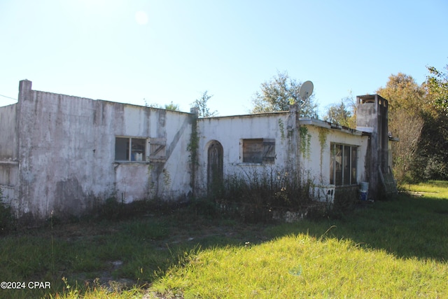 view of side of property with a yard