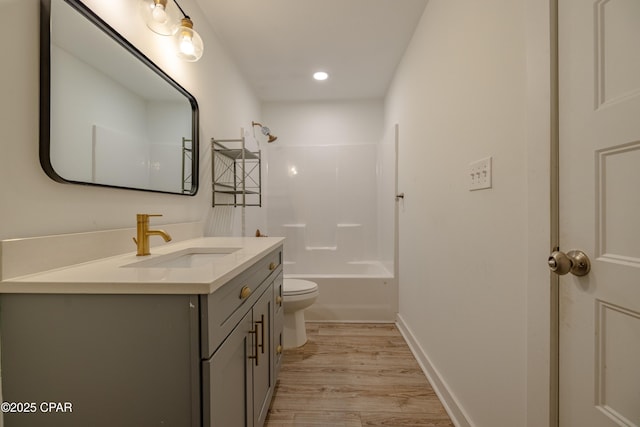 full bathroom featuring toilet, vanity, bathing tub / shower combination, and hardwood / wood-style flooring