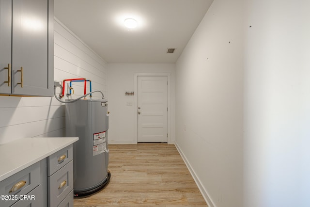 utility room featuring electric water heater