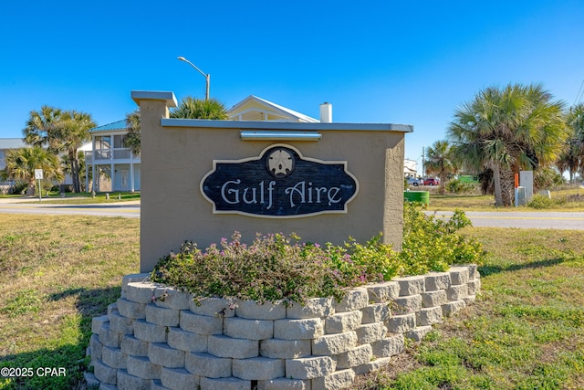 community / neighborhood sign with a lawn