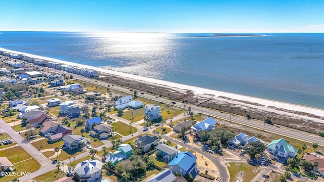 drone / aerial view featuring a water view and a beach view