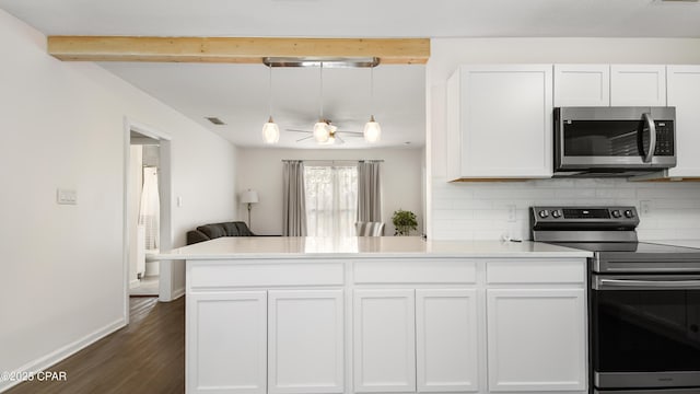 kitchen with appliances with stainless steel finishes, pendant lighting, white cabinets, kitchen peninsula, and beam ceiling