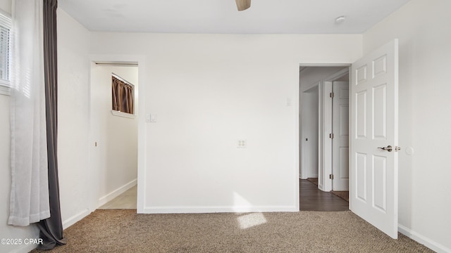 unfurnished bedroom featuring carpet and ceiling fan