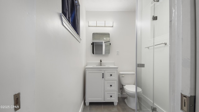 bathroom with vanity, toilet, and tile patterned flooring