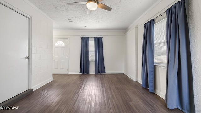 entrance foyer featuring dark wood-type flooring, ceiling fan, crown molding, and a textured ceiling