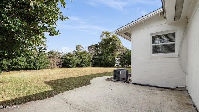 view of yard featuring cooling unit and a patio area