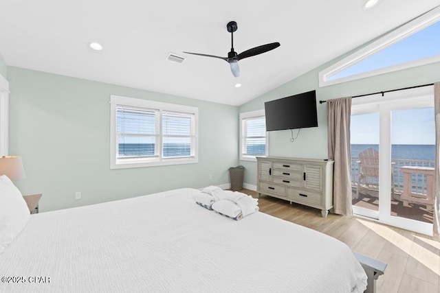 bedroom featuring ceiling fan, access to exterior, light hardwood / wood-style flooring, and vaulted ceiling