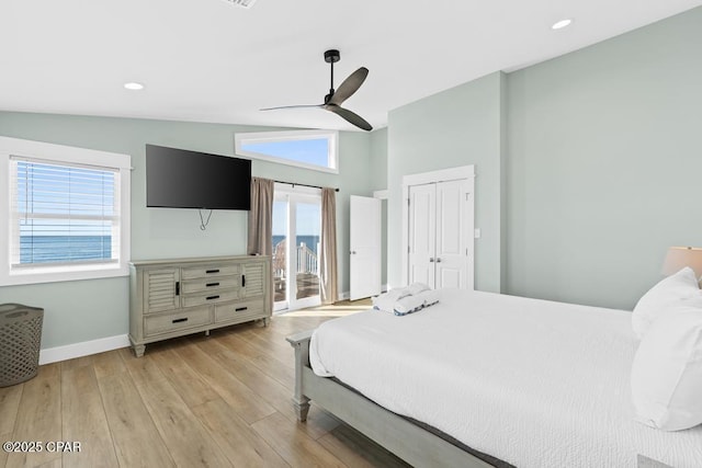 bedroom with ceiling fan, multiple windows, access to outside, and vaulted ceiling