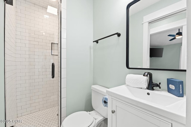 bathroom featuring an enclosed shower, vanity, ceiling fan, and toilet