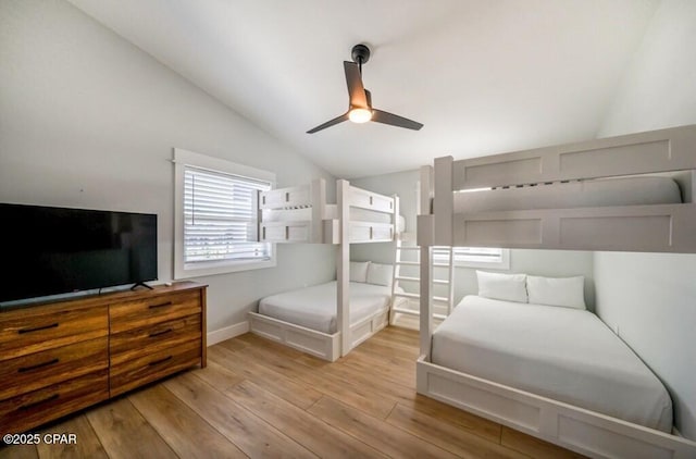 bedroom featuring ceiling fan, lofted ceiling, and light hardwood / wood-style floors