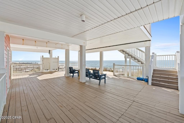 wooden terrace featuring a water view