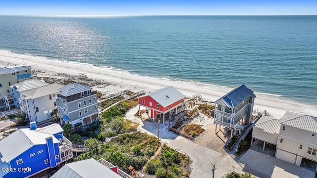 drone / aerial view featuring a water view and a view of the beach