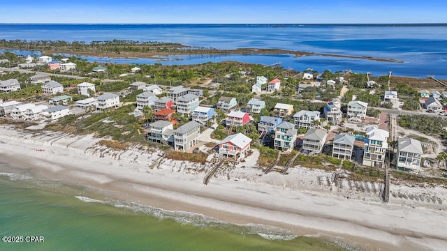 aerial view with a water view and a beach view