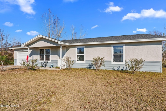 ranch-style home with a garage and a front lawn