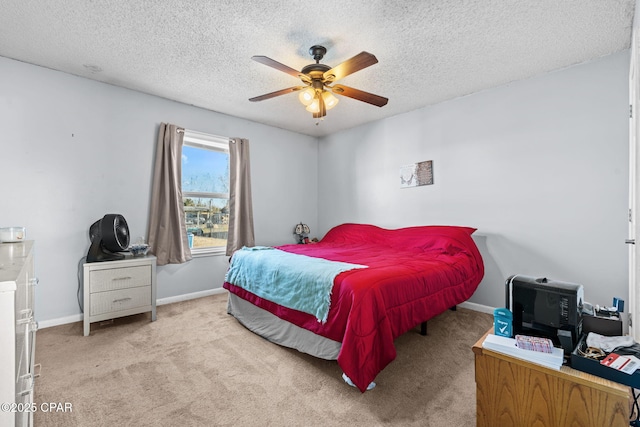 bedroom with light colored carpet, a textured ceiling, and ceiling fan