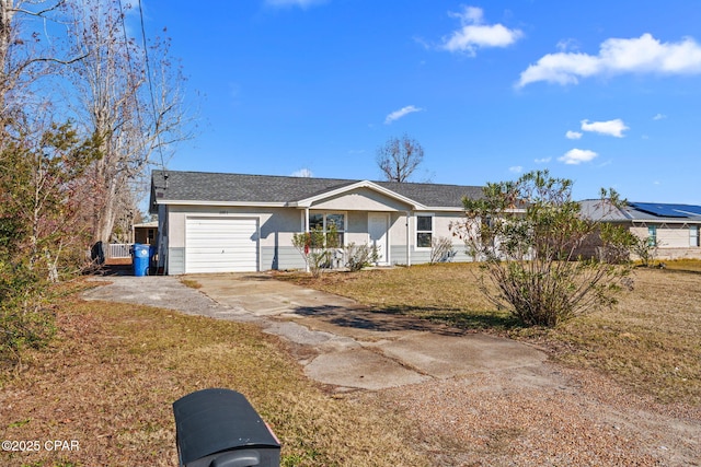 ranch-style home with a garage and a front yard