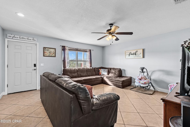 tiled living room with ceiling fan and a textured ceiling