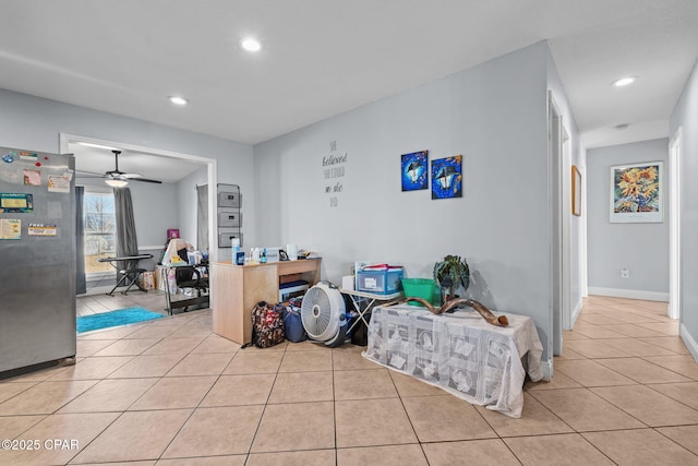 interior space featuring light tile patterned floors and ceiling fan