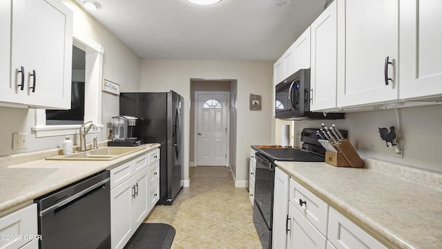 kitchen featuring black appliances, sink, and white cabinetry