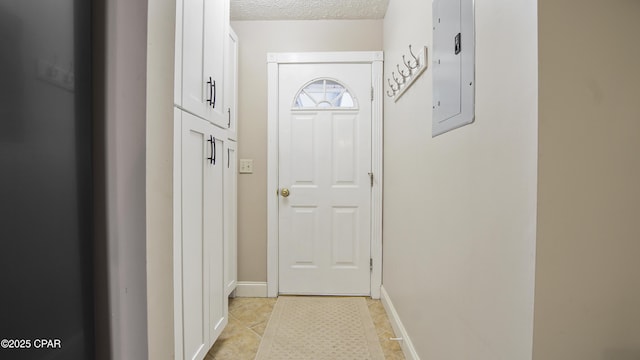 doorway to outside featuring a textured ceiling, electric panel, and light tile patterned flooring