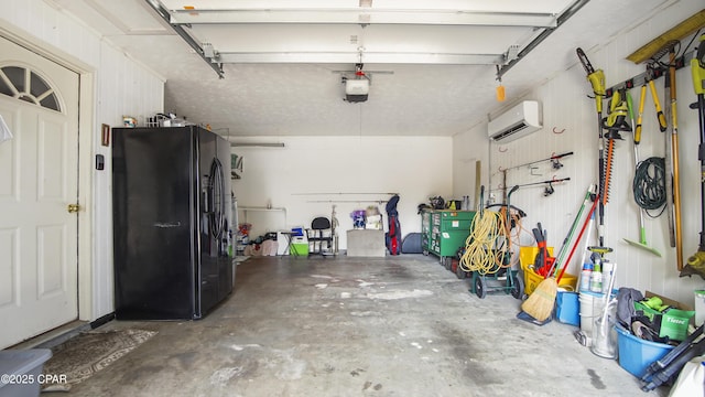 garage with a wall mounted AC, a garage door opener, and black fridge