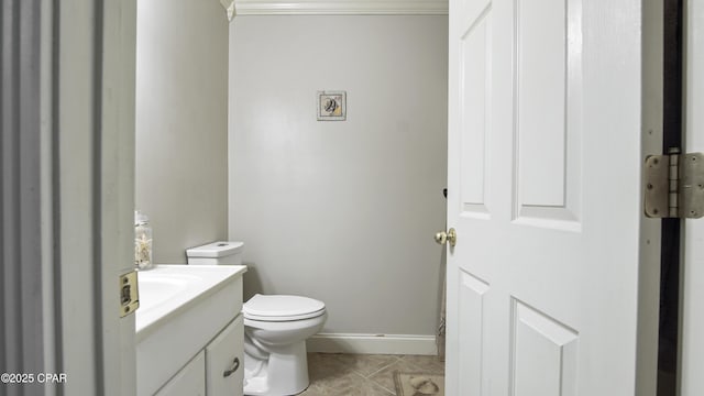 bathroom featuring toilet, ornamental molding, tile patterned floors, and vanity