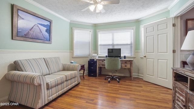 home office featuring ceiling fan, a textured ceiling, dark hardwood / wood-style flooring, and ornamental molding