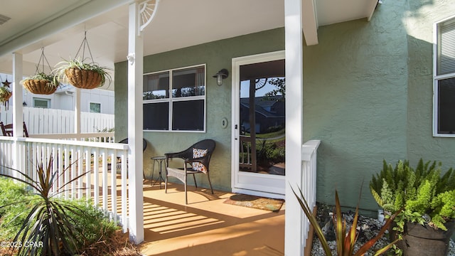 view of exterior entry with a porch