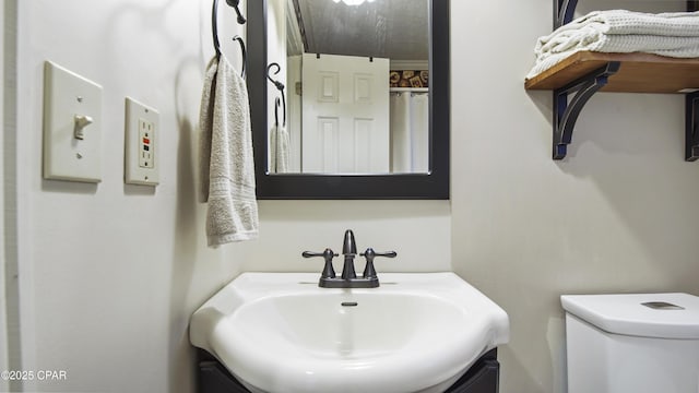 bathroom featuring toilet and vanity