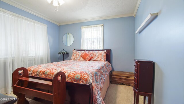 bedroom with ceiling fan, a textured ceiling, multiple windows, and ornamental molding