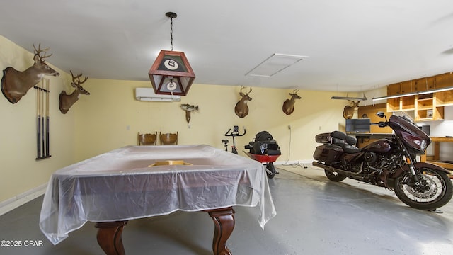 interior space featuring an AC wall unit, billiards, and concrete flooring