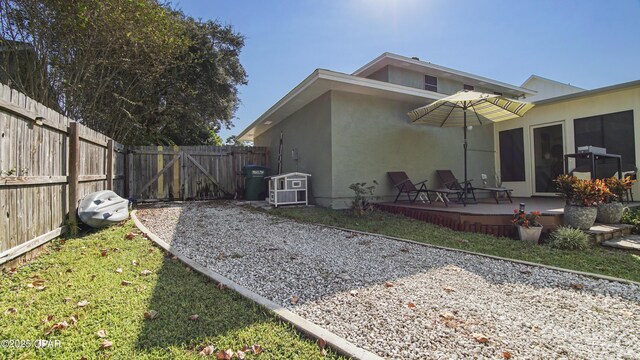 back of property with a lawn and a patio