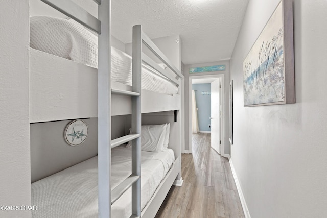 bedroom featuring hardwood / wood-style floors and a textured ceiling