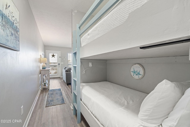 bedroom featuring hardwood / wood-style flooring and a textured ceiling