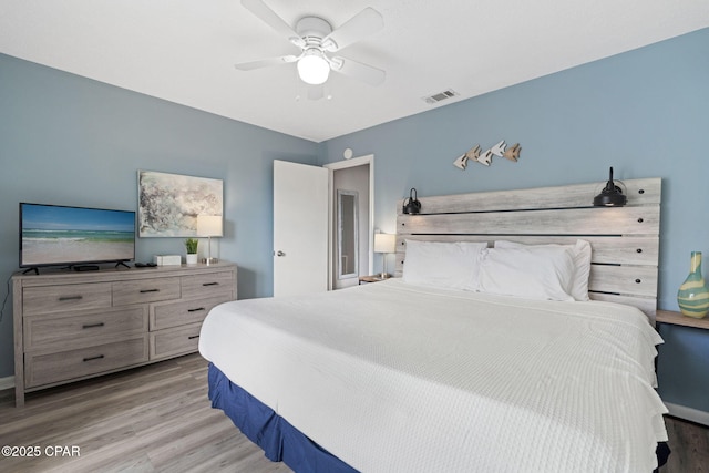 bedroom featuring ceiling fan and light hardwood / wood-style flooring