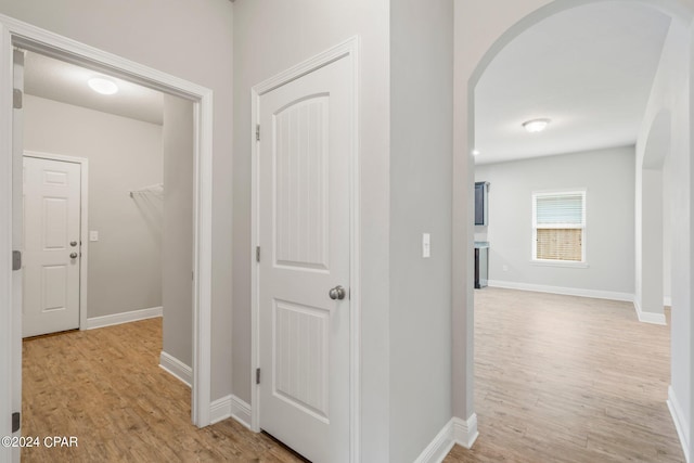 hallway with light hardwood / wood-style flooring