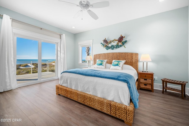 bedroom with a water view, ceiling fan, and wood-type flooring