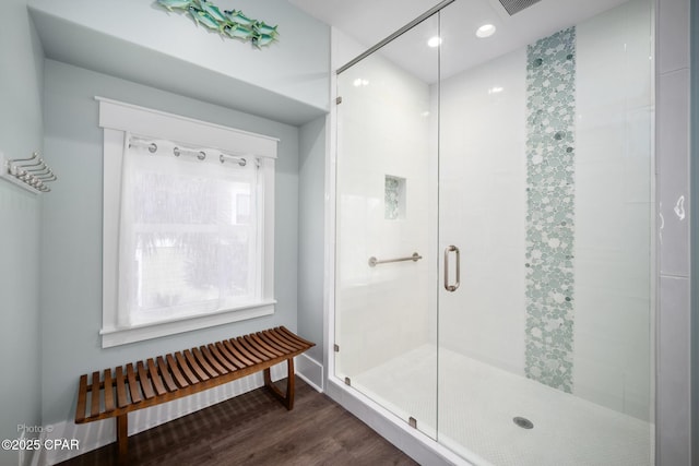 bathroom featuring a shower stall and wood finished floors