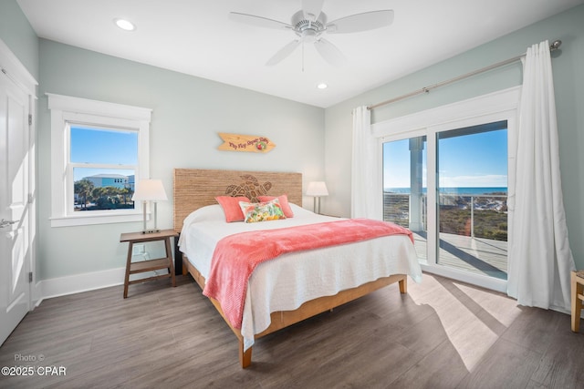 bedroom with ceiling fan, access to exterior, dark hardwood / wood-style flooring, and multiple windows