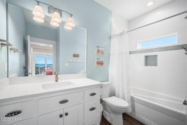 full bathroom featuring toilet, vanity, shower / bath combination with curtain, and hardwood / wood-style flooring