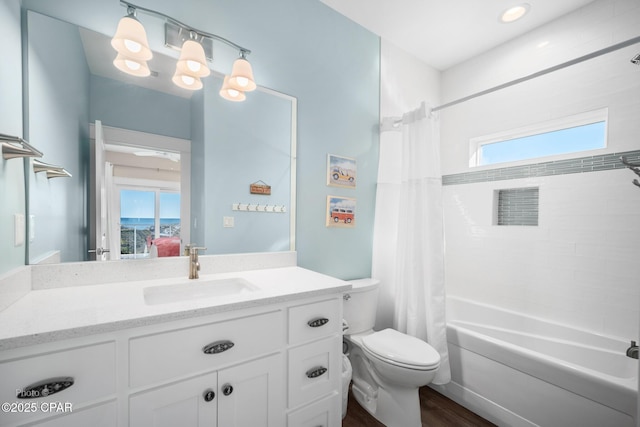 bathroom featuring plenty of natural light, vanity, toilet, and shower / bath combo with shower curtain