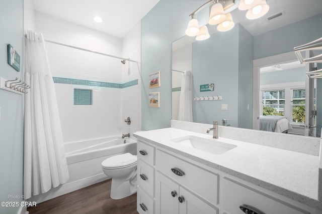 121 Gulf Hibiscus Dr, Port St Joe, FL 32456 - ensuite bathroom with visible vents, vanity, wood finished floors, ensuite bath, and shower / bathtub combination with curtain