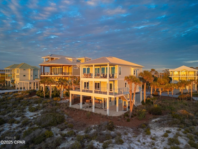 121 Gulf Hibiscus Dr, Port St Joe, FL 32456 - rear view of property with a patio area, stairway, metal roof, and a balcony