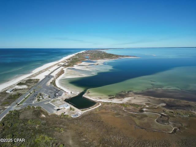 birds eye view of property featuring a water view and a beach view