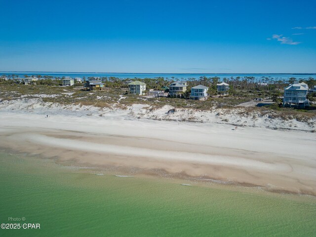 aerial view featuring a water view and a beach view