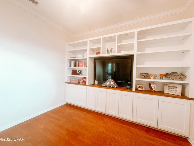 unfurnished living room with crown molding and light wood-type flooring