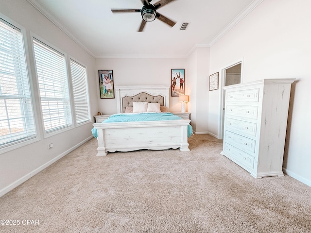 carpeted bedroom with ornamental molding and ceiling fan